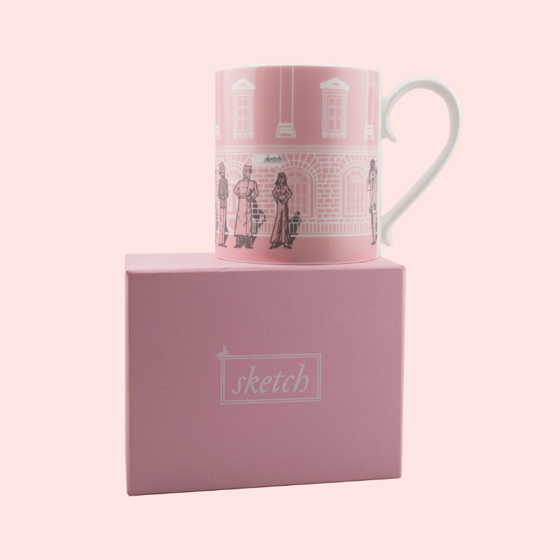 Load image into Gallery viewer, Pink mug with a design on a matching pink box, featuring the 'sketch' brand.