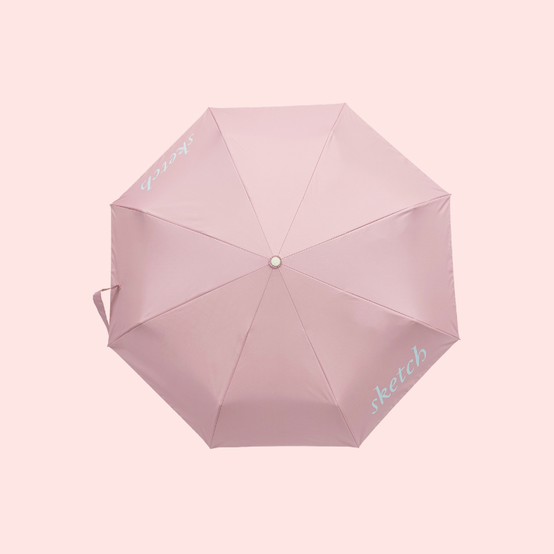 Load image into Gallery viewer, Pink umbrella with 'Sketch' branding on a light pink background