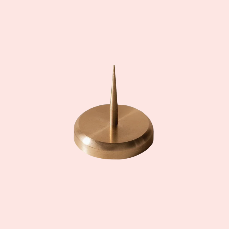 Load image into Gallery viewer, Gold-colored decorative object with a pointed top on a light pink background